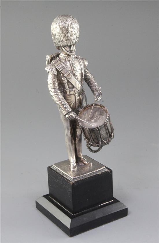 A 1980s silver miniature model of a 1st Battalion Scots Guards drummer (filled), by Carrington & Co, figure 20.8cm.